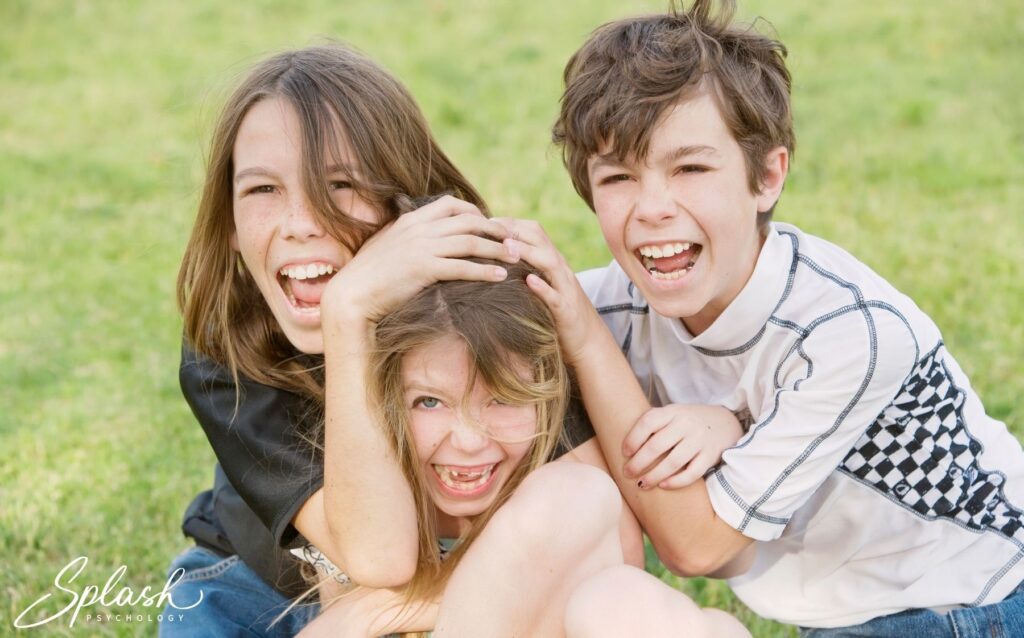 Three children roughhousing together